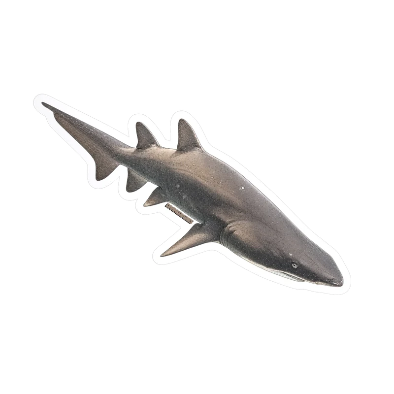 A die cut sticker of a grey nurse shark in profile, speckled and ragged toothed. Drag it to tilt it.